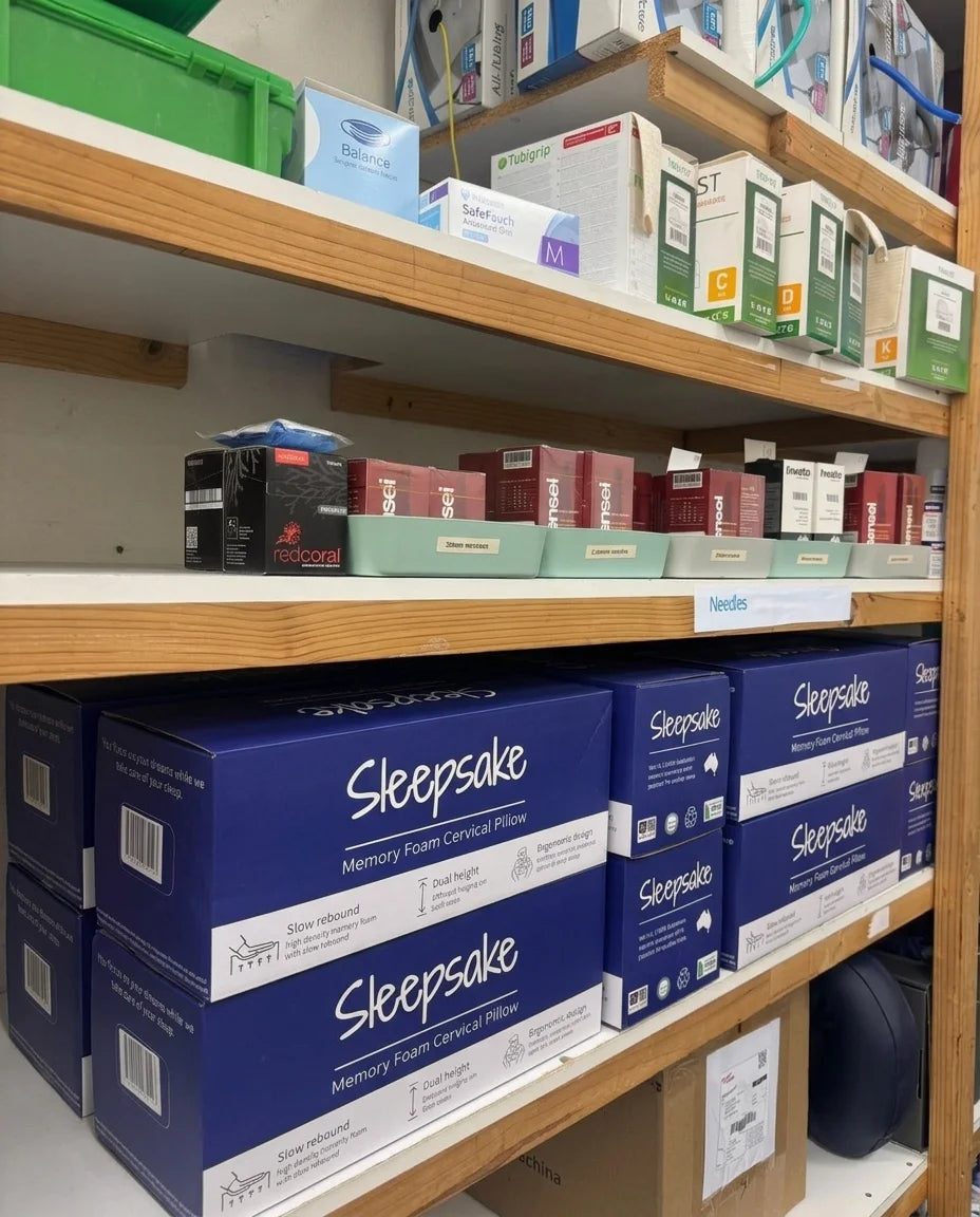 Shelves with boxes of 'Sleepsake' pillows in a store setting.